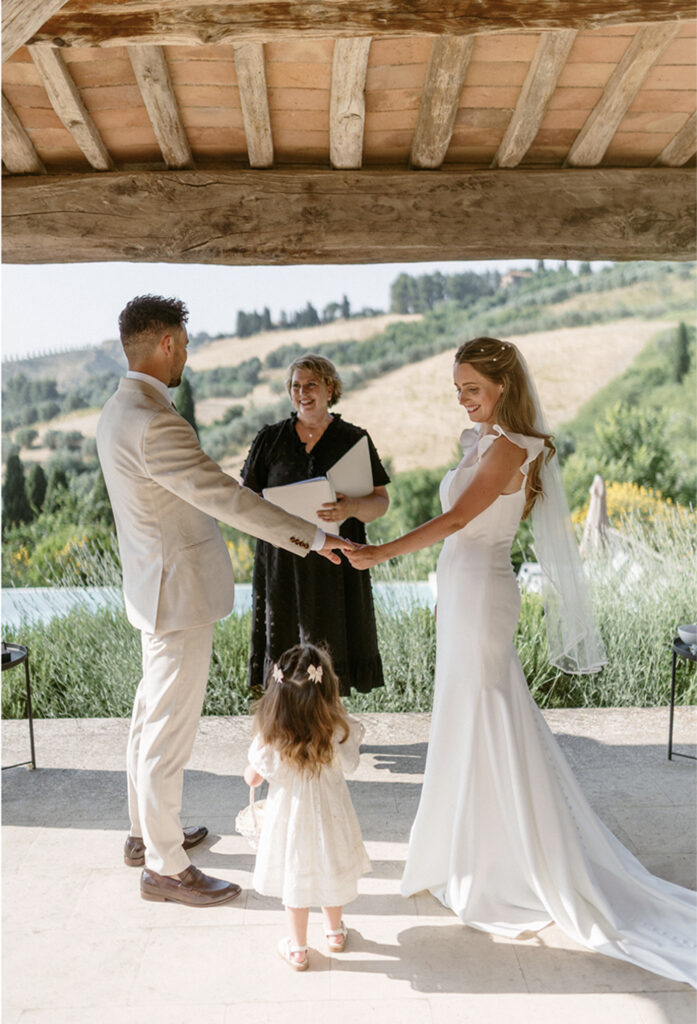 Wedding officiant leading a ceremony overlooking the Tuscan countryside