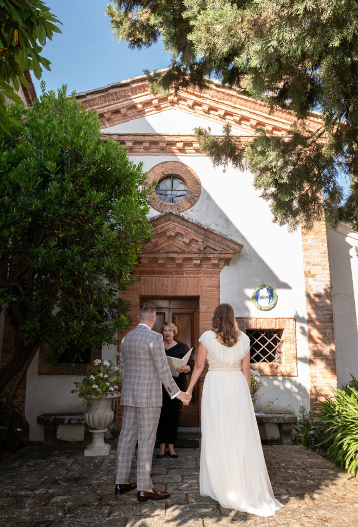Outdoor wedding ceremony in the courtyard of a historic Tuscan villa