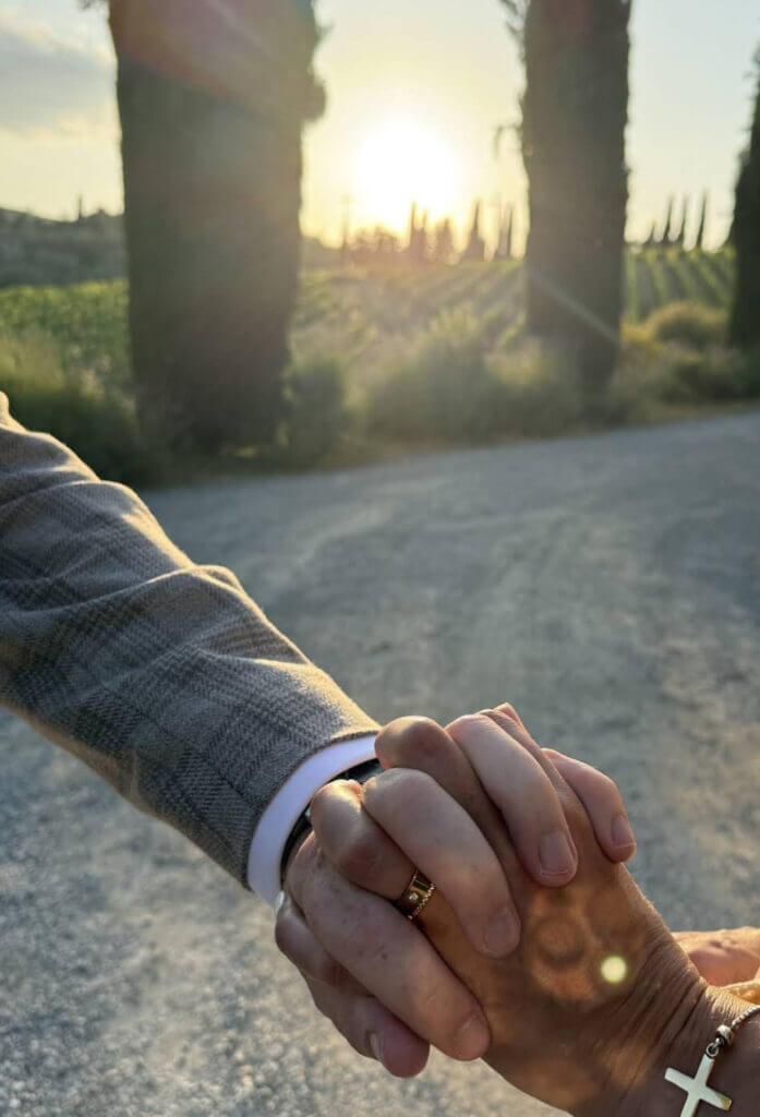 Bride and groom standing in warm sunlight during their Tuscany wedding ceremony