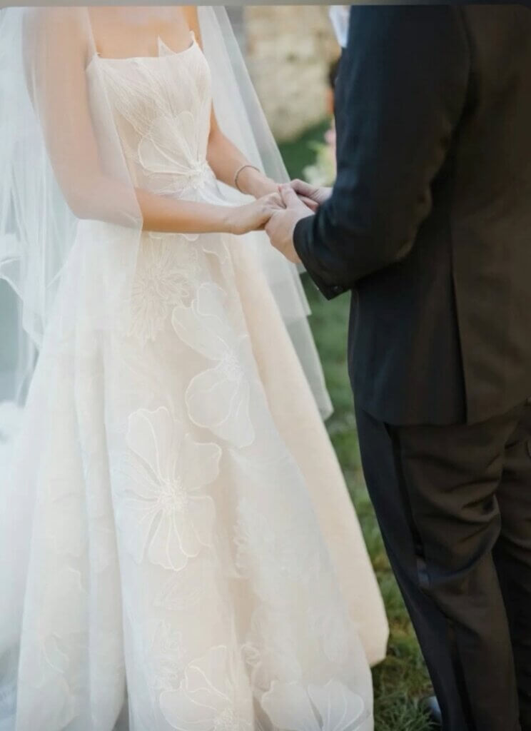 Bride and groom holding hands during their intimate wedding ceremony